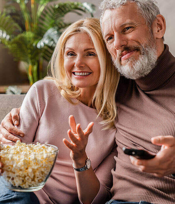 Couple watching TV together.